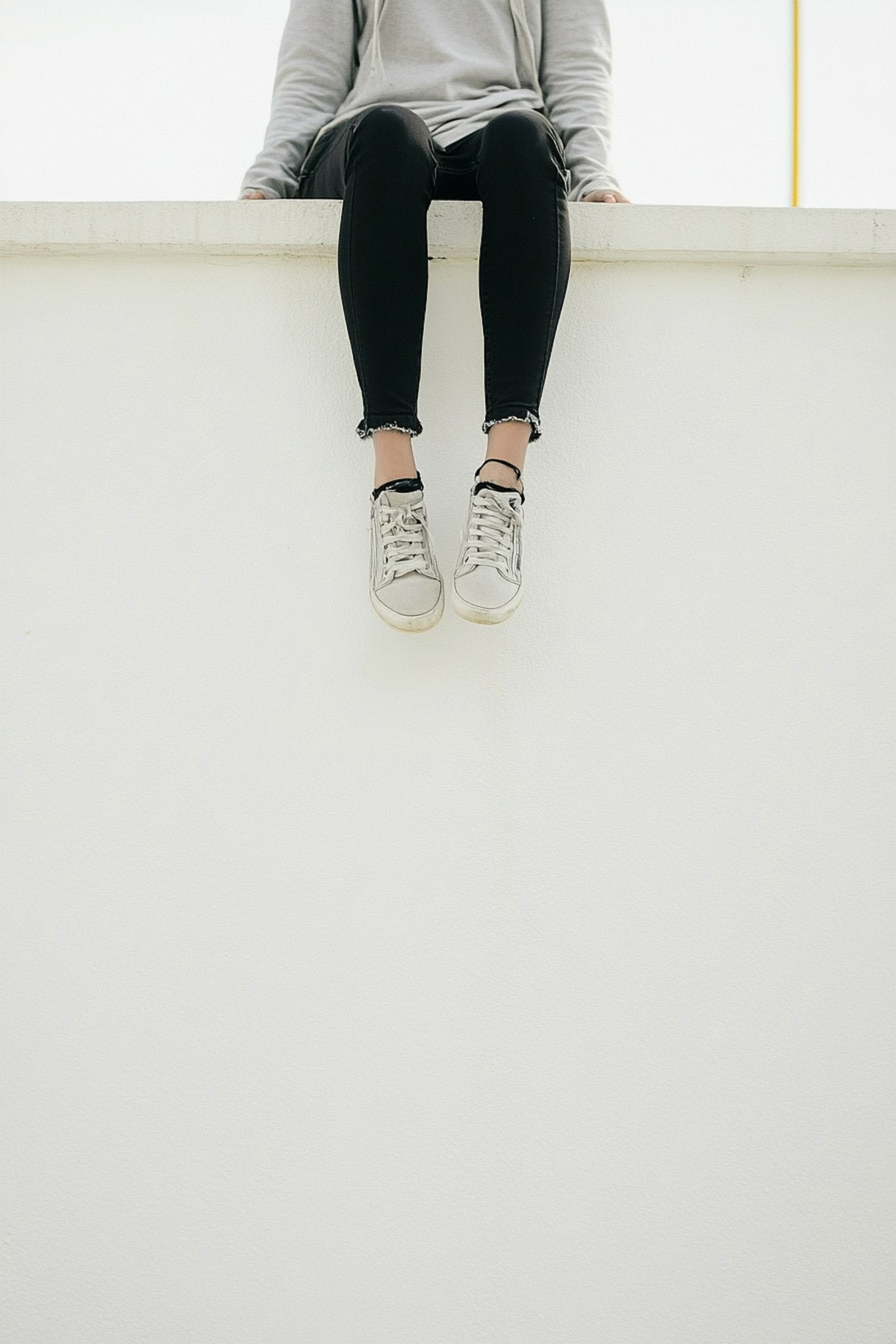 Girl is sitting on a gate